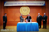 Hanyang Cyber University Chancellor shakes hands with Anaheim University Dean 